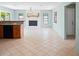 An open floor plan connects to the living room with a stone fireplace and plenty of natural light at 3353 Montano Ave, Spring Hill, FL 34609