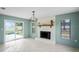 A cozy living room features a decorative fireplace, natural light, and sliding glass doors to the outdoor area at 3353 Montano Ave, Spring Hill, FL 34609