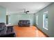 Bright living room featuring wood floors, neutral walls, abundant natural light, and comfortable seating at 3353 Montano Ave, Spring Hill, FL 34609
