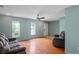 Well-lit living room offering wood floors, neutral paint, comfortable couches, and abundant light at 3353 Montano Ave, Spring Hill, FL 34609
