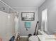 Bathroom featuring a toilet, shower, artwork of the Eiffel Tower, and white walls at 35051 Colony Hills Dr, Zephyrhills, FL 33541