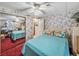 Bedroom with a bed, mirrored closet, ceiling fan, and floral wallpaper at 35051 Colony Hills Dr, Zephyrhills, FL 33541