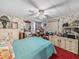 Bedroom featuring a desk, cabinets, floral wallpaper, and a ceiling fan at 35051 Colony Hills Dr, Zephyrhills, FL 33541