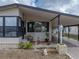 Charming home featuring covered parking, a cozy front porch, and well-maintained landscaping at 35051 Colony Hills Dr, Zephyrhills, FL 33541