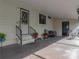 Inviting covered parking area with a cozy outdoor seating space, perfect for relaxing and enjoying the fresh air at 35051 Colony Hills Dr, Zephyrhills, FL 33541
