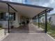 Covered parking and welcoming entryway of a single-story home, with a glimpse of the neighborhood at 35051 Colony Hills Dr, Zephyrhills, FL 33541