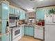 Bright kitchen with ample storage, white appliances, and a window over the sink at 35051 Colony Hills Dr, Zephyrhills, FL 33541