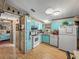 Functional kitchen featuring blue cabinets, white appliances, and ample counter space at 35051 Colony Hills Dr, Zephyrhills, FL 33541