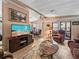 Bright and inviting living room with a large TV, ceiling fan, and views into the dining area at 35051 Colony Hills Dr, Zephyrhills, FL 33541