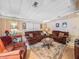 Cozy living room featuring comfortable seating, a decorative rug, and warm lighting at 35051 Colony Hills Dr, Zephyrhills, FL 33541