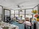 Bright sunroom with many windows, ceiling fan, and comfortable seating offering relaxing views at 35051 Colony Hills Dr, Zephyrhills, FL 33541