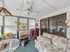 Relaxing sunroom with a floral sofa, plenty of light, and comfortable rocking chair at 35051 Colony Hills Dr, Zephyrhills, FL 33541