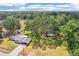 Overhead view of house with mature trees and grass yard at 403 Westbrook Ave, Brandon, FL 33511
