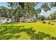 Expansive backyard showing grass, shed, trees, and fence line at 403 Westbrook Ave, Brandon, FL 33511