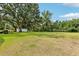 A sprawling backyard with mature trees and a white shed at 403 Westbrook Ave, Brandon, FL 33511