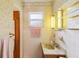 A bathroom with a single sink, tile walls and decorative wallpaper at 403 Westbrook Ave, Brandon, FL 33511
