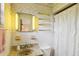 A bathroom with a single sink, tile walls and decorative wallpaper at 403 Westbrook Ave, Brandon, FL 33511