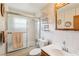 Well-lit bathroom with a shower-tub combo, vanity, and decorative wallpaper at 403 Westbrook Ave, Brandon, FL 33511