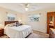 Bedroom featuring a ceiling fan, windows providing natural light, and a comfortable bed at 403 Westbrook Ave, Brandon, FL 33511