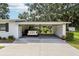 A spacious carport offers ample parking and storage, enhancing the functionality of this home and well maintained landscaping at 403 Westbrook Ave, Brandon, FL 33511