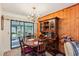 Cozy dining area featuring a round table with chairs, a hutch, and sliding glass doors to the patio at 403 Westbrook Ave, Brandon, FL 33511