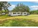 A charming single-story home is set on a large lot with a well maintained lawn and mature landscaping at 403 Westbrook Ave, Brandon, FL 33511
