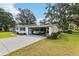 Well-maintained front yard and convenient carport parking enhance the curb appeal of this charming single-story home at 403 Westbrook Ave, Brandon, FL 33511