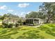 Single-story home features a screened in lanai and a covered carport with driveway at 403 Westbrook Ave, Brandon, FL 33511