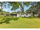 Back of home showing enclosed porch and manicured lawn at 403 Westbrook Ave, Brandon, FL 33511