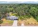Charming single-story home with a manicured lawn and mature trees providing ample shade on a sunny day at 403 Westbrook Ave, Brandon, FL 33511