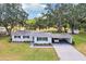 Aerial view of home featuring a carport, established trees and lawn at 403 Westbrook Ave, Brandon, FL 33511