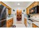Kitchen view into dining room and its hutch. Appliances are white at 403 Westbrook Ave, Brandon, FL 33511