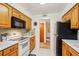 Well-lit kitchen features white appliances and ample cabinet space at 403 Westbrook Ave, Brandon, FL 33511