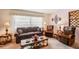 Cozy living room featuring traditional furnishings, a large window, and decorative accents, perfect for relaxation and entertaining at 403 Westbrook Ave, Brandon, FL 33511