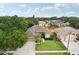 Inviting aerial shot of a home with a green lawn, a graceful walkway, and mature trees enhancing curb appeal in a neighborhood setting at 4511 Swift Cir, Valrico, FL 33596