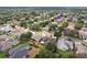 Aerial view of a residential area, highlighting backyard pools, fenced yards, and proximity to community amenities at 4511 Swift Cir, Valrico, FL 33596