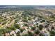 Aerial view of a residential neighborhood, surrounded by lush greenery, featuring homes nestled among mature trees and manicured lawns at 4511 Swift Cir, Valrico, FL 33596