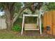 Charming backyard featuring a wooden swing beneath a mature tree, offering a tranquil and inviting outdoor retreat at 4511 Swift Cir, Valrico, FL 33596