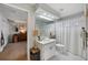 Charming bathroom with a large mirror, white vanity, and a peek into the adjacent bedroom, offering a cozy and inviting space at 4511 Swift Cir, Valrico, FL 33596