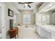 Bright bathroom features a large soaking tub, vanity, and separate glass shower at 4511 Swift Cir, Valrico, FL 33596
