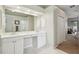 Bright bathroom featuring a vanity with dual sinks and access to a walk-in shower at 4511 Swift Cir, Valrico, FL 33596