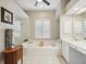 Bright bathroom features a large soaking tub, vanity, and separate glass shower at 4511 Swift Cir, Valrico, FL 33596