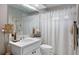 Bathroom featuring a vanity and toilet, with a shower covered with a white curtain at 4511 Swift Cir, Valrico, FL 33596
