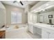 Bright bathroom features a large soaking tub, vanity, and separate glass shower at 4511 Swift Cir, Valrico, FL 33596