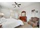 Spacious bedroom with neutral paint, a large dresser, and a comfortable accent chair at 4511 Swift Cir, Valrico, FL 33596