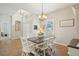 Bright dining room featuring a vaulted ceiling, large windows, and stylish white furniture at 4511 Swift Cir, Valrico, FL 33596
