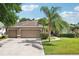 Charming home featuring a well-manicured lawn, mature landscaping, and a spacious three car garage at 4511 Swift Cir, Valrico, FL 33596