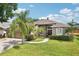 Charming home with lush lawn and mature landscaping, featuring a well-manicured lawn at 4511 Swift Cir, Valrico, FL 33596