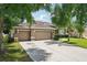 Charming home featuring a well-manicured lawn, mature landscaping, and a spacious three car garage at 4511 Swift Cir, Valrico, FL 33596