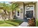 Inviting front entrance featuring a double door with floral wreaths, decorative sidelights, and manicured landscaping at 4511 Swift Cir, Valrico, FL 33596